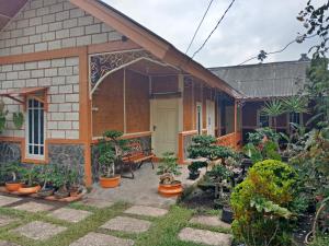 a house with a patio with potted plants at Villa Daffa Ciwidey in Ciwidey