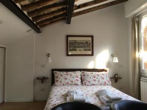 a bedroom with a bed with towels on it at Montoro 15 Attic Suite in Rome