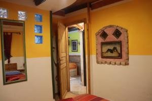 Habitación con paredes amarillas y espejo en la pared. en Appartamento Domu Mea 258 A en Santa Maria