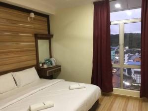 Postel nebo postele na pokoji v ubytování Haji Saudi Hotel