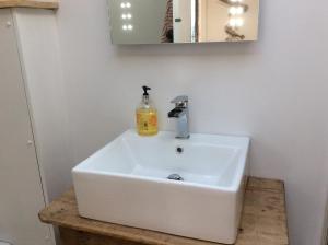 a white sink in a bathroom with a mirror at Passengers House in Whitstable