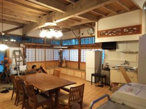 a kitchen and dining room with a table and chairs at Minpaku Sarai Nikkoya in Okkia