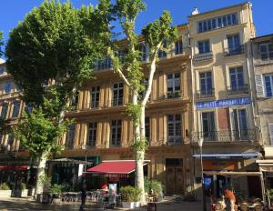 a building with a tree in front of it at Les Suites du Cours & Spa in Aix-en-Provence