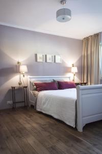 a bedroom with a white bed with red pillows at Seesterne Comfort in Konstanz