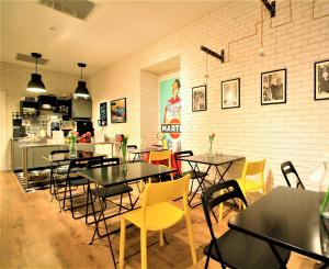 a restaurant with tables and chairs in a room at Daily Napoli - Lungomare in Naples