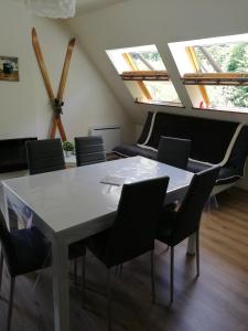 a table and chairs in a room with skylights at Appartement Bagnères de Luchon in Luchon