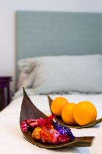 a plate of fruit on a table with oranges at Apartamentos RG Plaza de España in Seville