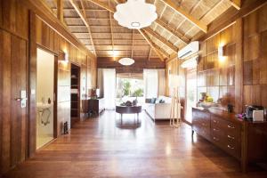 a large room with wooden walls and a ceiling at Tulia Zanzibar Unique Beach Resort in Pongwe