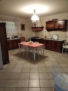 a kitchen with a pink table in the middle of it at Villa Maria in Isola delle Femmine
