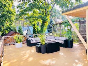 a patio with a couch and potted plants on it at Jurmala apartment in Jūrmala