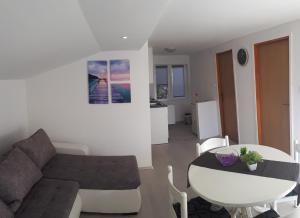 a living room with a couch and a table at Apartment Aquamarine in Vir
