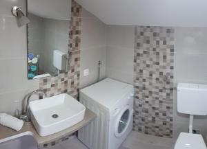 a white bathroom with a sink and a toilet at Apartment Aquamarine in Vir +24 photos