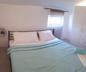 a bedroom with a large bed with blue sheets at Apartment Aquamarine in Vir