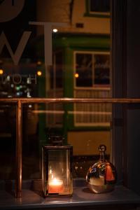 a candle and a lantern sitting on a table at Twenty Hotel and Bar in Boston