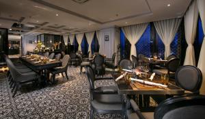 a restaurant with tables and chairs in a room at La Sinfonía Citadel Hotel and Spa in Hanoi