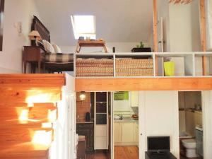 a living room with a loft bed and a kitchen at Central Lisbon Charming Loft in Lisbon
