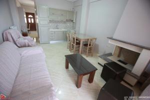 a living room with a couch and a table at Xenonas4seasons in Esokhória