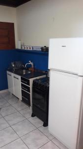 a kitchen with a stove and a white refrigerator at Flia Ocampo in Puerto Iguazú