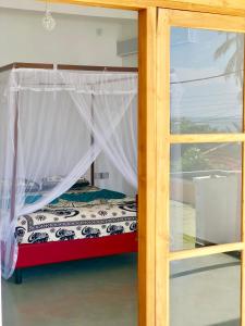 a bedroom with a bed and a window at Coppenrath Hostel in Tangalle +42 photos