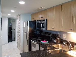 a kitchen with a stainless steel refrigerator and a sink at 1906 OO in Myrtle Beach