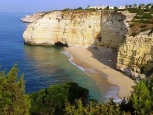 a view of a beach with a cave and the ocean at Apartamentos - Solar Vale Covo in Carvoeiro