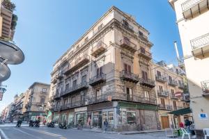 an old building on the corner of a street at Kasavucciria Apartments in Palermo