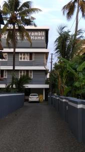 a building with a car parked in front of it at Madaparambil Tenants Home in Ernakulam
