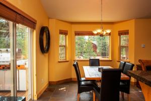 a dining room with yellow walls and a table and chairs at 5-Star Luxury Tahoe Cabin! Great Location! Pool Table!Darts! Poker! Ping Pong! Games! in South Lake Tahoe