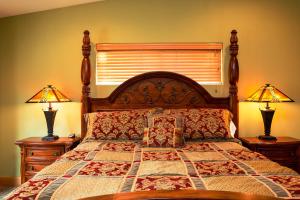 a bedroom with a large bed with two lamps at 5-Star Luxury Tahoe Cabin! Great Location! Pool Table!Darts! Poker! Ping Pong! Games! in South Lake Tahoe