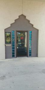 una puerta delantera de una tienda de vidrio azul en Mission Inn, en San Antonio