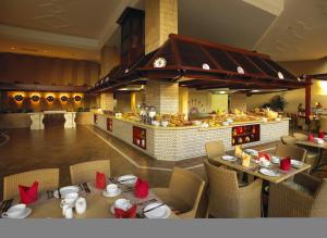 
a restaurant with a large buffet table with food on it at Soho Hotel & Casino at Sun City in Sun City
