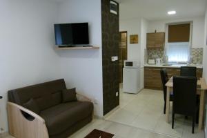 A kitchen or kitchenette at Wolf House Apartman