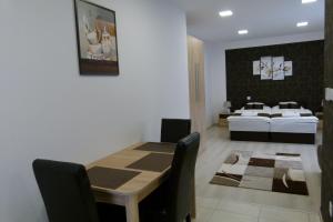 A bed or beds in a room at Wolf House Apartman
