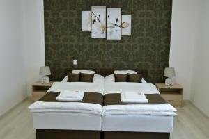 A bed or beds in a room at Wolf House Apartman