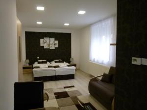 A bed or beds in a room at Wolf House Apartman