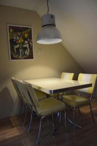 
a dining room table with chairs and a lamp at De Terp in Hernen
