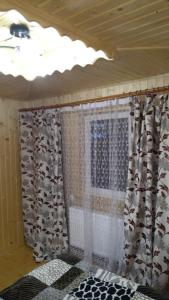 a room with a window with curtains on it at Базилік in Yaremche