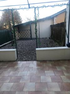 a patio with a gate and a fence at la Salaberie in Villeréal +4 photos