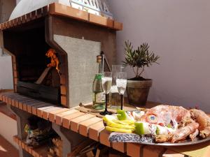 a plate of food on a table with a pizza oven at Faro Town House in Faro