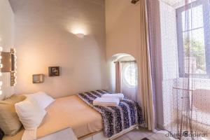 
a bedroom with a bed and a window at Faro Town House in Faro
