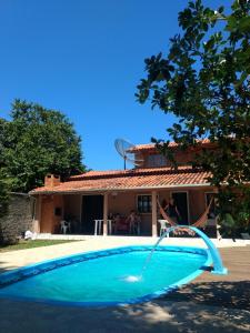 a swimming pool in front of a house at Casa do Cantinho in Imbituba