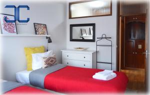 a bedroom with a bed with a red blanket at Country Apartment by JC in Porto