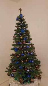 a christmas tree with blue ornaments on it at Lorenz Apartment in Hattingen