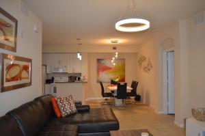 a living room with a couch and a dining room at Fort Myers Luxury Vacation Condo in Fort Myers