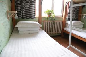 Cama o camas de una habitación en Harbin North International Youth Hostel