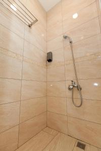 W łazience znajduje się prysznic ze szklanymi drzwiami. w obiekcie Yuan Qiwu Homestay w mieście Pinghe