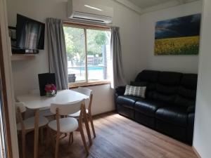 a living room with a table and a couch at Euroa Caravan Park in Euroa