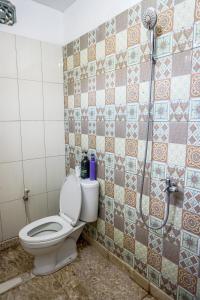 a bathroom with a toilet and a shower at Rumah Panjaitan in Yogyakarta