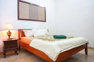 A bed or beds in a room at Rumah Panjaitan