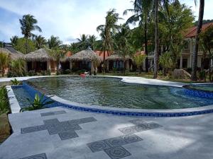 a swimming pool in the middle of a resort at Phu Quoc Kim 2 Beach Front Resort in Phu Quoc